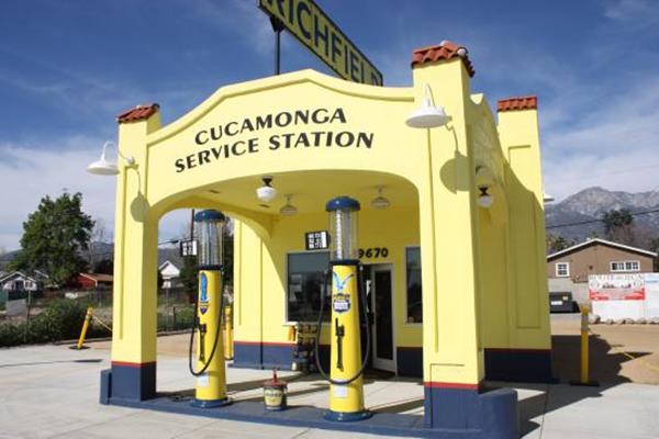 yellow and blue restored Richfield gas station, flat canopy, box pillars, vintage gas pumps, small cubic office