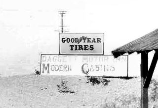 Daggett Cabins sign sign saying DAGGETT MODERN CABINS by inspection station c.1930