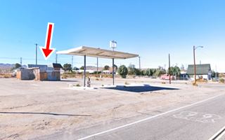 Daggett Shell Station US66 vacant office in the rear, butterfly canopy by the highway (right) US 66 shield painted on roadway