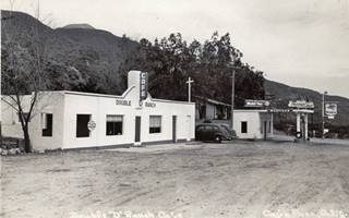 Double D Ranch Cafe, looking south black and white, cafe and Mobil gas station to the left, mountains behind, highway 66 in front c.1950s