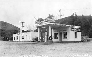 Double D Ranch gas station, Cafe, looking south black and white, cafe and Mobil gas station to the rights mountains behind, highway 66 in front c.1950s