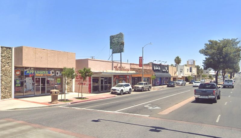 2023 north side 200s block of E Main- US 66 Barstow CA US 66, median with trees, cars, stores, signs in 2023, color