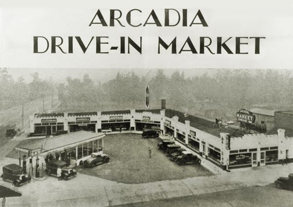 c.1930 Drive In Market Arcadia CA Route 66 black and white c.1930 corner gas station, L-layout building 1 story, signs on flat roof around it with stores and shops, cars by gas pumps ARCADIA DRIVE-IN MARKET printed on upper part of the card