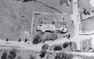 Eaton’s Santa Anita Drive In 1940, Arcadia CA black and white, 1940 aerial view of a crossroads with a drive in restaurant on the upper left corner of crossing. Railroad and US 66 run left to right bottom of image