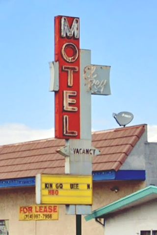 motel neon sign red box vertical white letters spell MOTEL, white structure reads VACANCY
