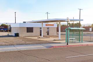 no service bays, two parallel pump islands, flat canopy in anold filling station, Needles