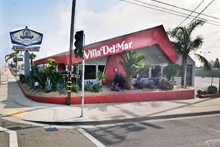 former Denny’s diner with boomerang roof and original sign on a corner
