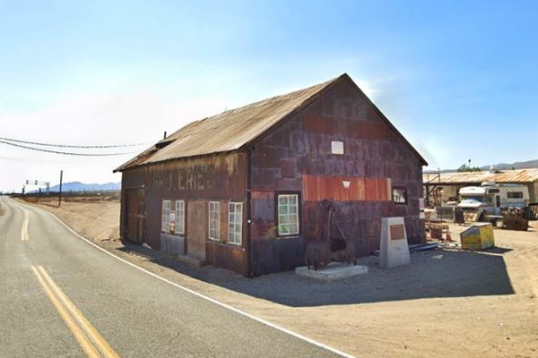 rusting decrepit shed with galvanized steel walls, a former garage