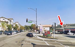 Glendora Ave and Route 66, Glendora color, 2022 gas station gable roof, to the right, avenues with cars at the intersection, traffic light, buildings