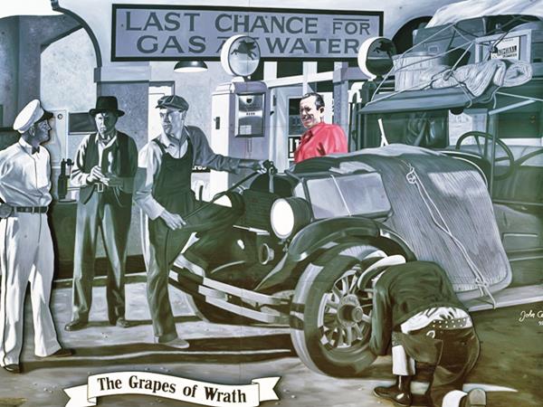 billboard with scene from Grapes of Wrath movie in gray tones, and Steinbeck in color