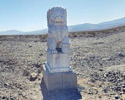 Guardian lion by Chris Normand, 2016 marble lion on a cinderblock pedestal in the desert