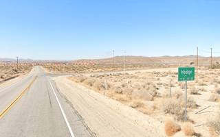 junction in the desert, Hodge town road sign, dry area, bushes, US66 left, mountains in the distance