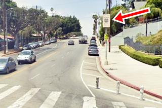 Route 66 alignment sign on Broadway and Mission Sts Los Angeles, Route 66 color, red arrow shows a sign on a post by N Broadway, cars, buildings and pedestrian X-ing