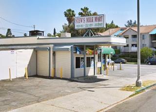 color, store former 1930s gas station office occupies area under the flat canopy