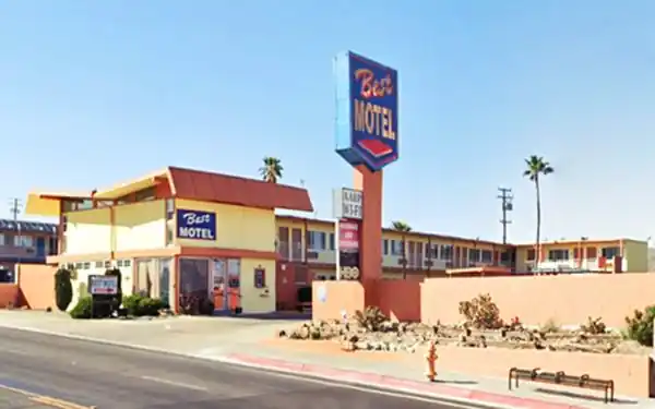 motel building neon sign right, US66 in front