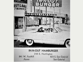 In-n-Out Hamburgers, 1950s Arcadia black and white hamburger drive-in, In-N-Out sign, convertible with teens, railroad overpass behind, c.1950s.