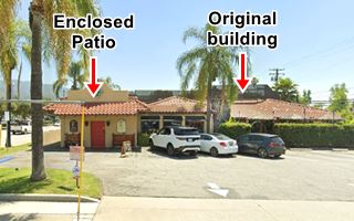 former Casa Janara restaurant nowadays Arcadia US66 red tiled hip roof building, cars parked to the right, Spanish style room to the left, palm trees
