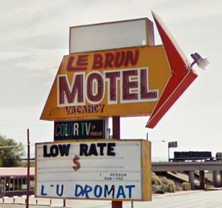 yellow neon sign red frame, arrow and letters, many panels