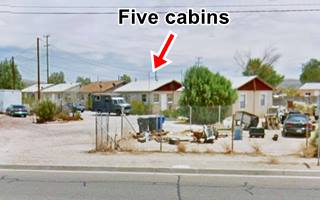 cabins of Wes Barstow Motel 2012 cabins, gable roofed, in a line, trees, US 66 in the foreground