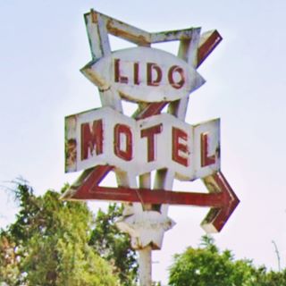1950s Lido Motel neon sign US 66 motel neon sign with red arrow and white frame supporting words LIDO MOTEL in red with a star below