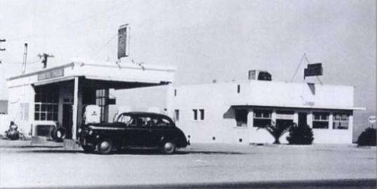 1947 Ludlow Cafe and Union 76 filling station black and white 1947. Left: gas station, flat canopy, box shaped office, car, left: cafe