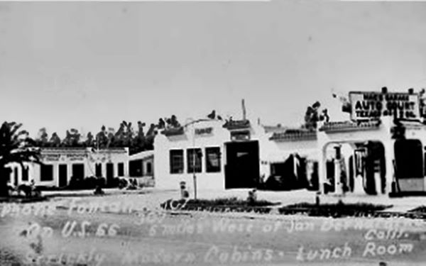 black and white 1930s, garage in the middle, cabins to the left and service station right.