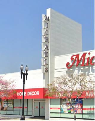 Michaels, historic neon sign neon sign with vertical panels each holding a red letter spelling MICHAELS on the facade of a white building
