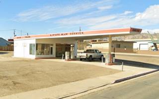 long triangular canopy over pumps, small office, a Union 76 Minuteman gasg station