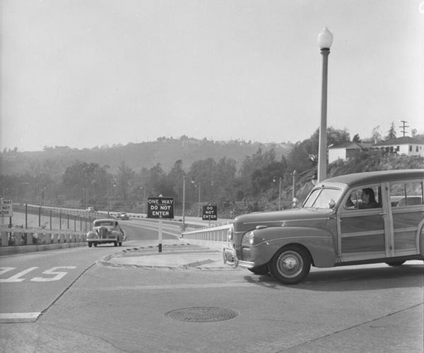 1942 Arroyo Seco Parkway signage, Los Angeles CA Route 66 black and white photo, 1942 station wagon on a street stops at exit ramp from the Arroyo Seco Parkway sign warns ONE WAY DO NOT ENTER