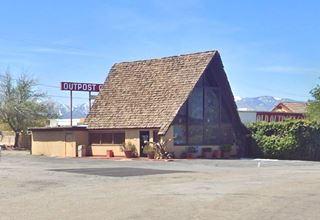 steep gable roofed building, glass wall mountains with snow in the distance