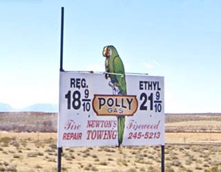 Polly gas station sign The 1950s Polly Gas station sign in Helendale with green parrott and prices from the 1950s, arid country behind