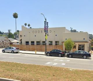 color blat roofed, single story building seen from old Route 66
