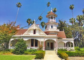 Lucky Baldwin's Queen Anne cottage nowadays, Arcadia CA color, forested garden surrounds a white 2 story Queen Anne building