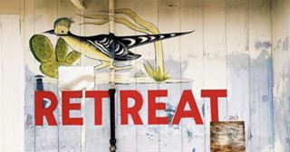Roadrunner sign restored restored road runner cafe sign bird and text in red letters: RETREAT