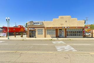 single story building with red caboose (left) a museum, US66 runs in front of it