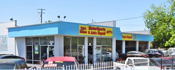 Former Williams Russell gas station ALT 66 S Bernardino icebox style former gas station now car repair shop, painted turquoise, glazed office on corner, service bays. Cars parked