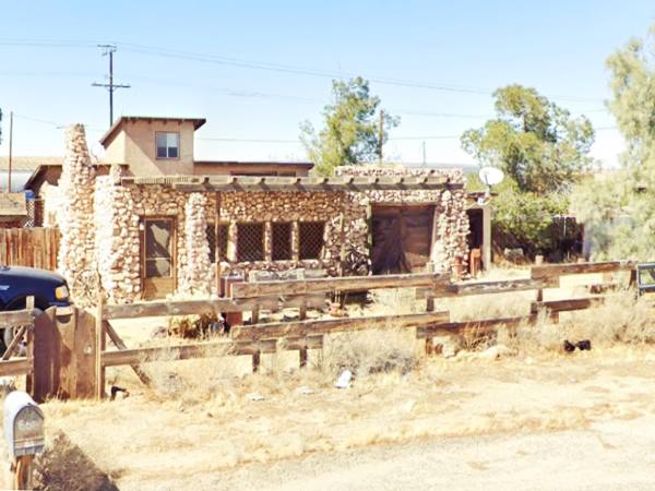 Sage Brush Inn, Helendale US66 nowadays round stone building with windows facing Route 66, trees to the right