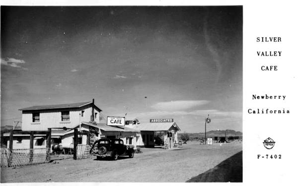 black and white 2 story gable roof building, a Cafe, and an adjacent gable building and canopy Texaco right, captioned SILVER VALLEY CAFE c.1930s