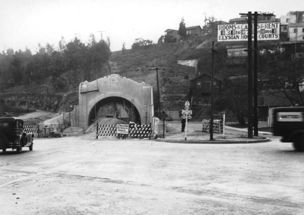 North portal fourth Figueroa St. tunnel 1935 Los Angeles CA Route 66 black and white photo, 1935, north portal 4th tunnel, hill with houses behind, cars, man, signs read US 66 and US 77