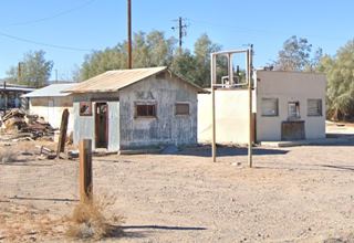 Sportsman’s Club nowadays US 66 Daggett CA gable roof building, empty neon sign Route 66 in front