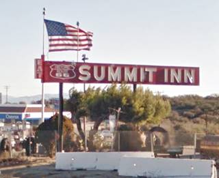 2015 Summit Inn neon sign, US 66 Hesperia red rectangular sign words SUMMIT INN and a US66 shield in white painted on it. American flag to the left