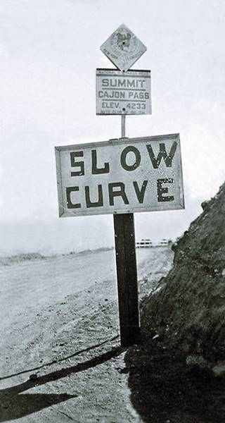 N.O.T. Summit Sign c.1920s Cajon Pass black and white c.1920s sign reads: SUMMIT CAJON PAS ELEV 4233, below it says SLOW CURVE, sheer mountain and gravel road