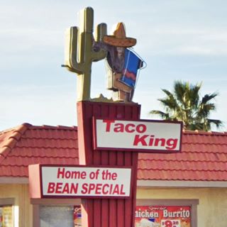 colorful Taco King neon sign depicting a Mexican character with a poncho and a typical hat leaning on a cactus
