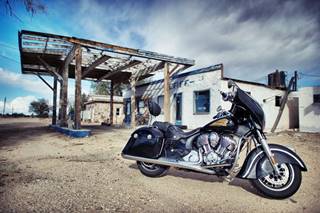 Wayside Cafe Market and Service station in Essex, California stucco single story vacant building, flat canopy, lacking top over empty pump island. Motorcycle