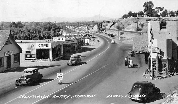 black and white 1930s-40s. US80, inspection station right, welcome center left, cars