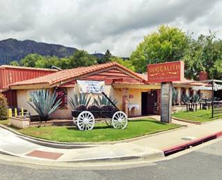 Spanish tiled gable roofed single story restaurant facing Route66