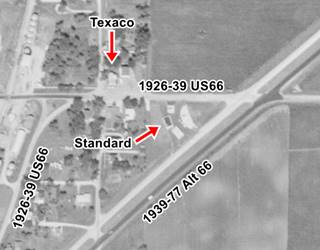1961 aerial view of Route 66 in Elwood IL black and white 1961 aerial photo. Route 66 four lane, old 66 and two service stations can be seen, streets, houses, fields
