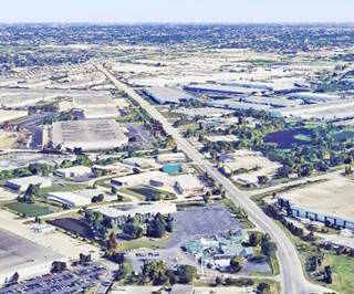 color, 2024 aerial view, warehouses, factories on both sides of a 4-lane former US 66