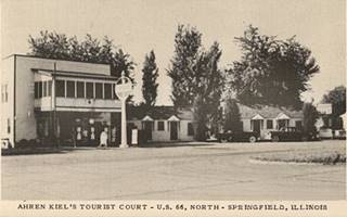 Ahren Kiel’s Service Station 1950s US66 black and white 1950s, 2 story bld. left, Standard gas sign, cars, cabins right US 66 in front