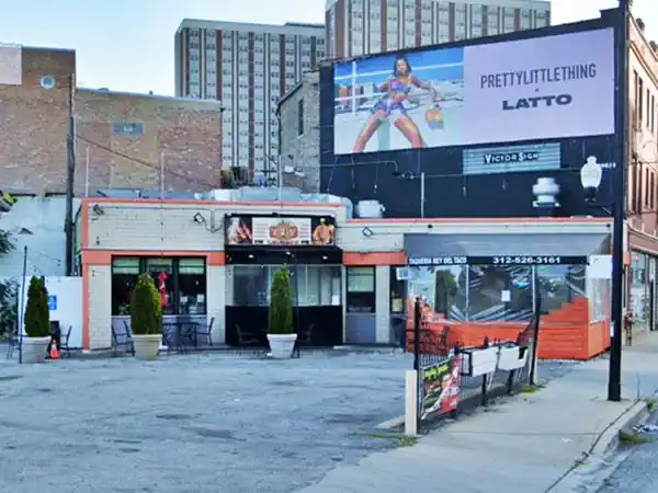 corner building, parking area in front, tiled facade, a taco restaurant